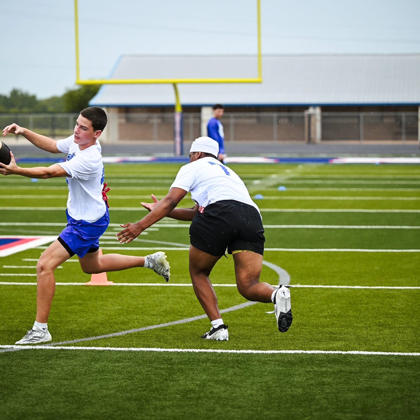 High school offensive lineman driving through a 40-yard sprint during Taylor Sports Performance lineman development training