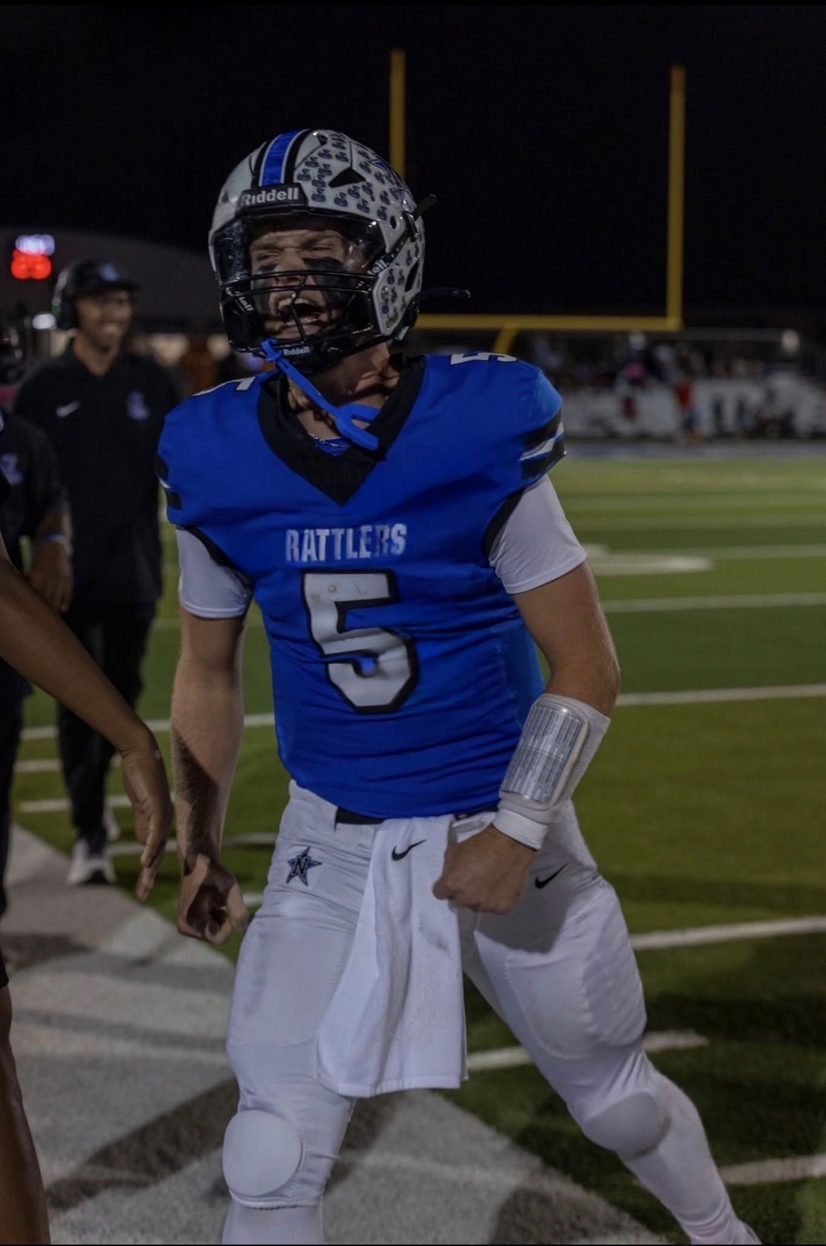 Jace Jablonski celebrating on the sideline in his Navasota Rattlers number 5 jersey