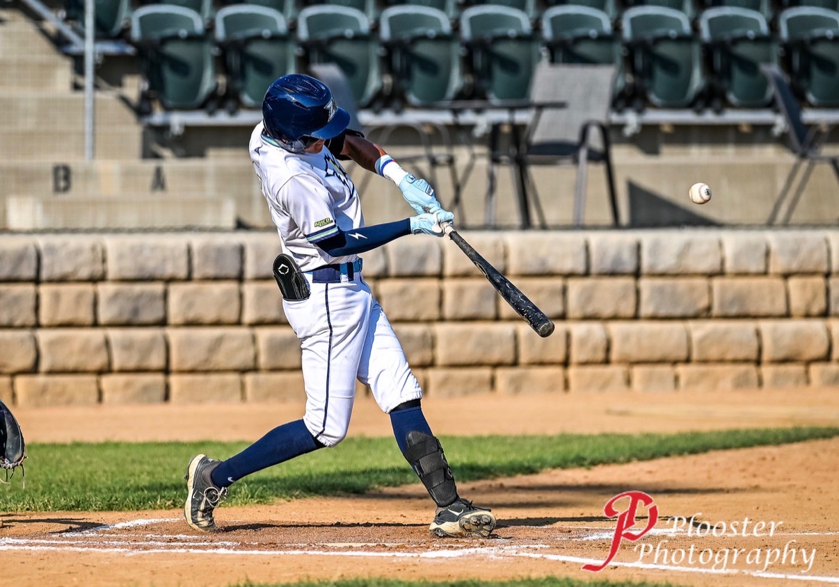 Cy Taylor driving a pitch during a collegiate baseball at-bat